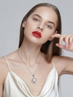 Load image into Gallery viewer, Silver Pearl Vortex Pendant White On-Hand Shot — Solisita