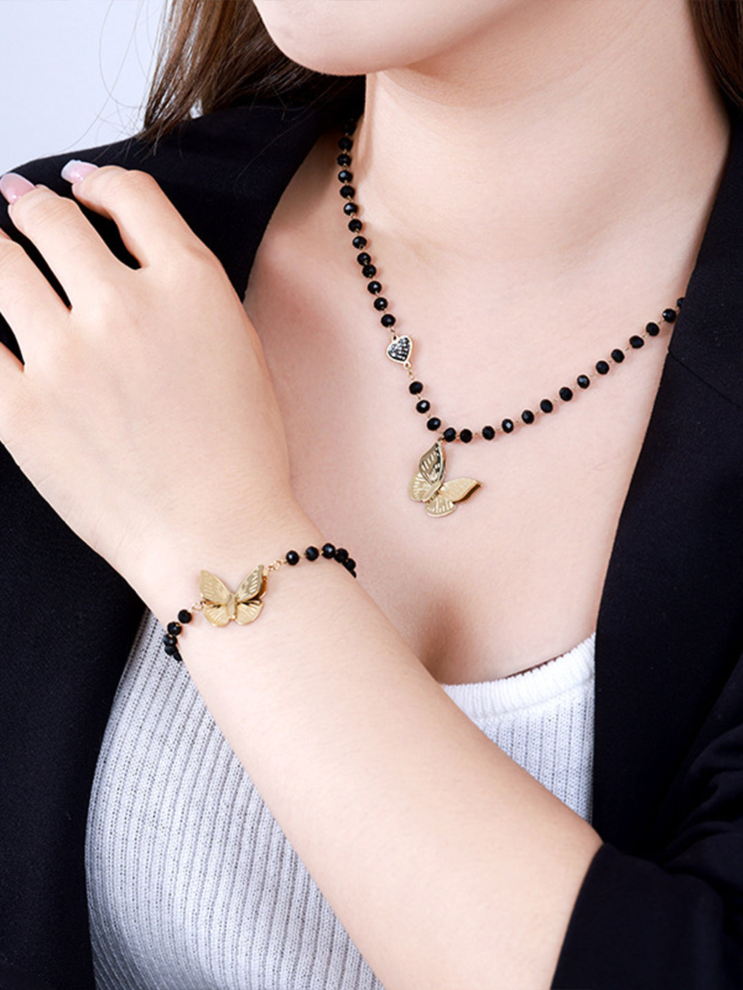 Gold Butterfly & Black Bead Jewellery Set Crystal On-Hand Shot — Solisita