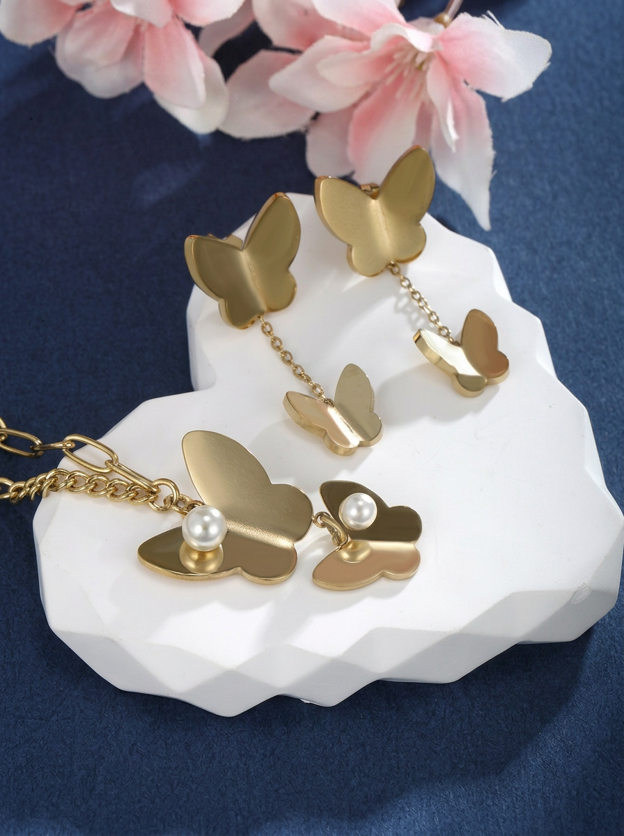 Matte Gold Butterfly & Pearl Asymmetrical Set Close-Up — Solisita