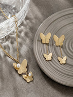 Load image into Gallery viewer, Matte Gold Butterfly &amp; Pearl Asymmetrical Set Front View — Solisita
