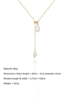 Load image into Gallery viewer, Pearl Lariat Necklace Gold Flat-Lay Styled — Solisita
