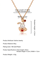 Load image into Gallery viewer, Rose Gold Bunny &amp; Pearl Necklace Gold-Tone Flat-Lay Styled — Solisita
